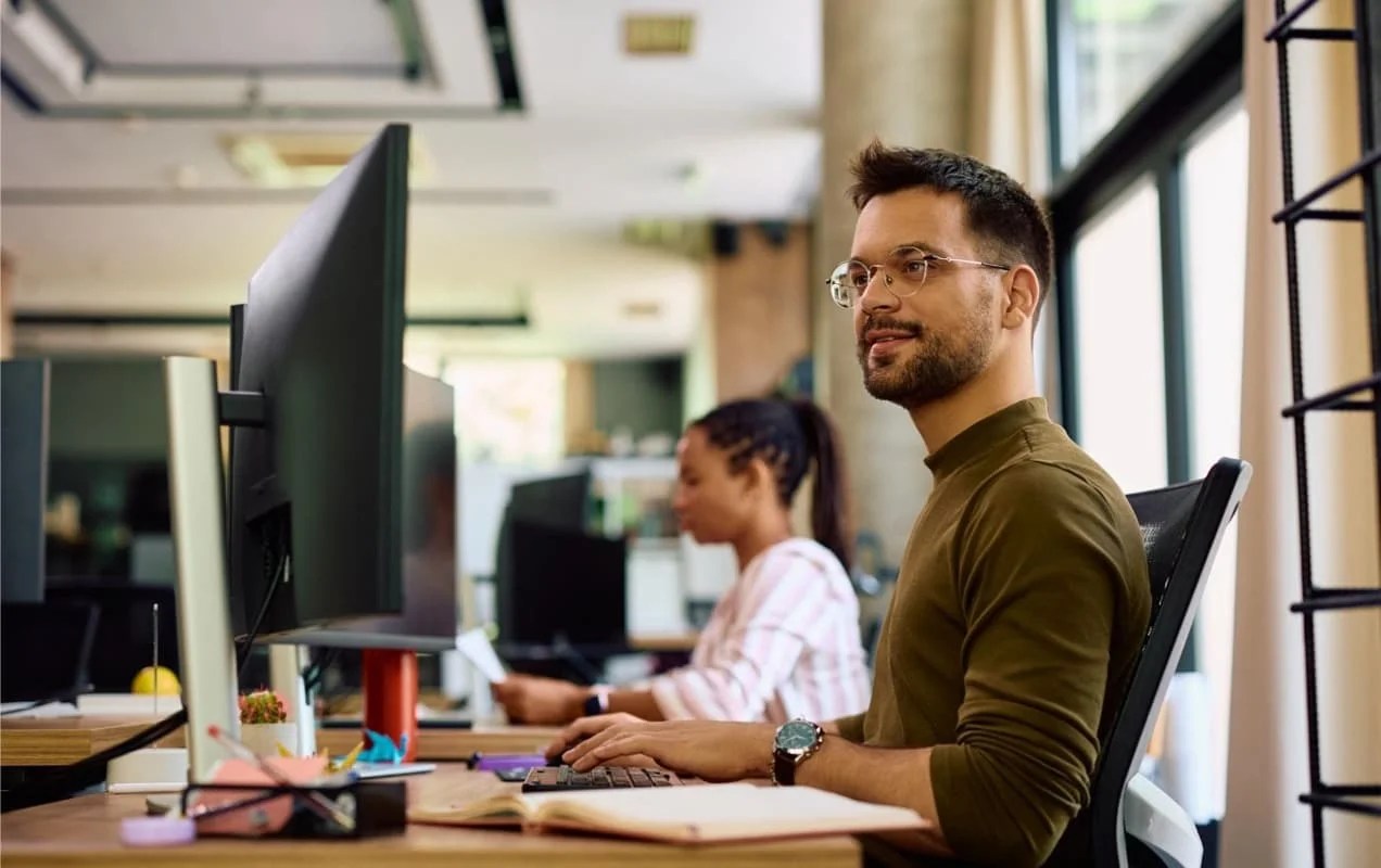 man working at a desk in an office space