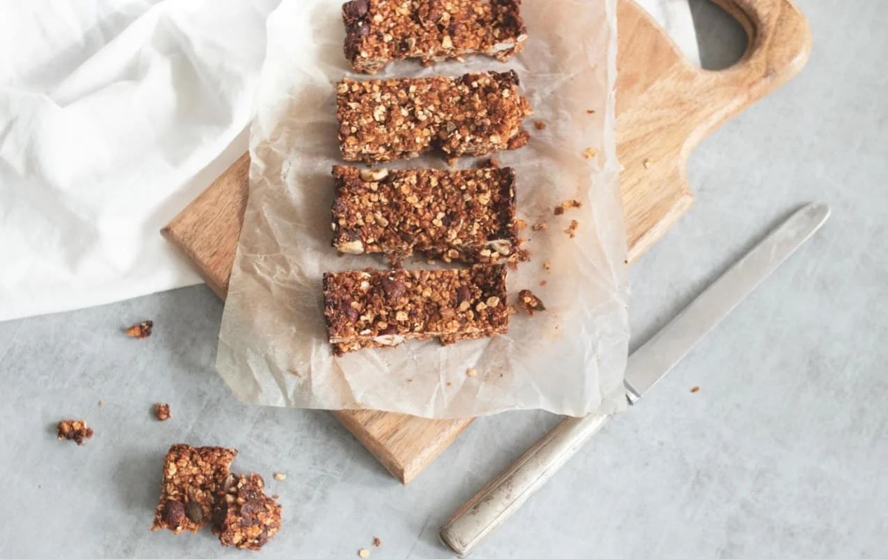 chunky granola bars cut on a wooden cutting board