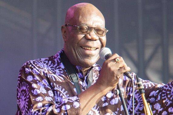 Manu Dibango holding a microphone